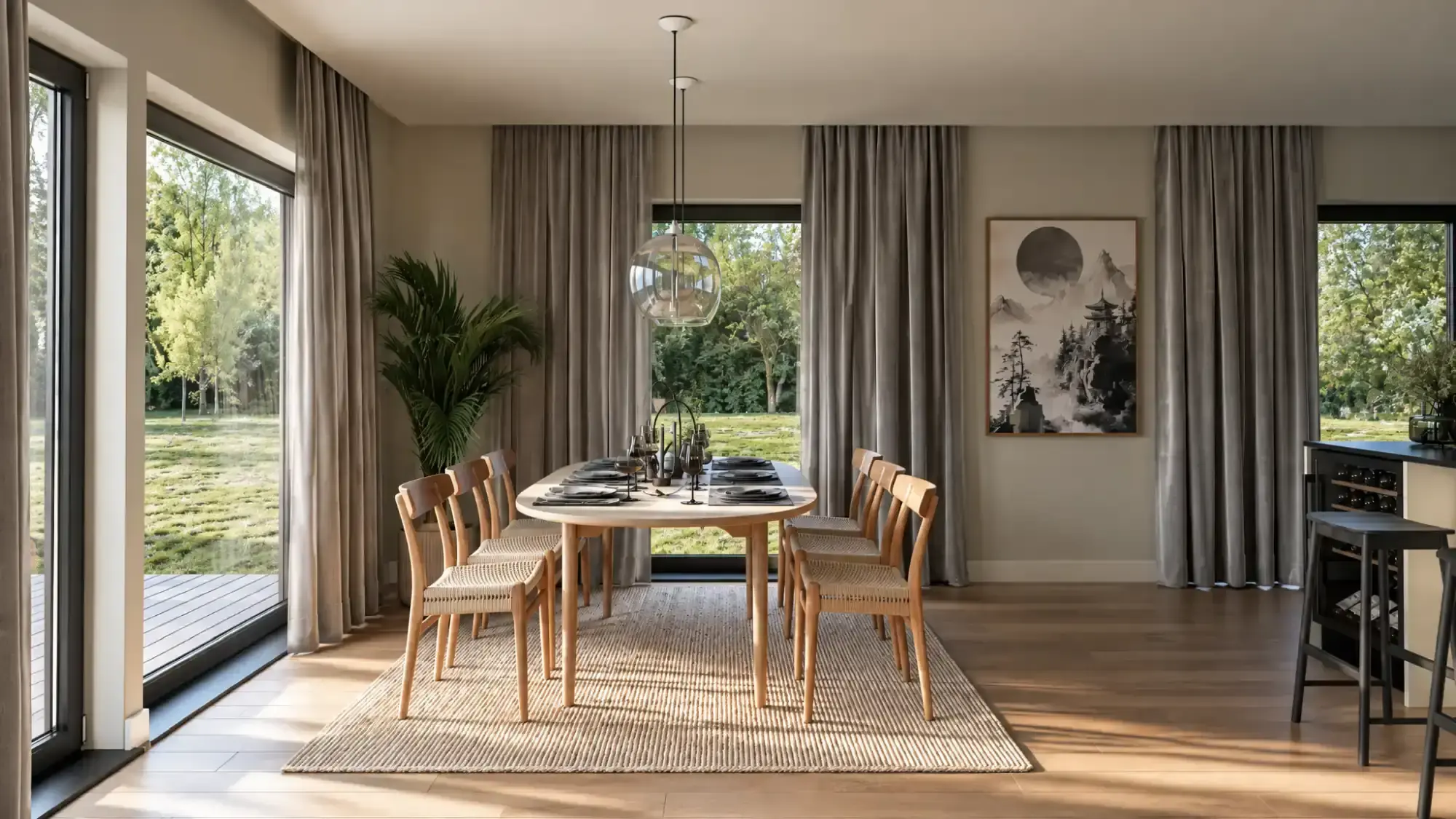 Dining room with an oval table and large windows overlooking the garden